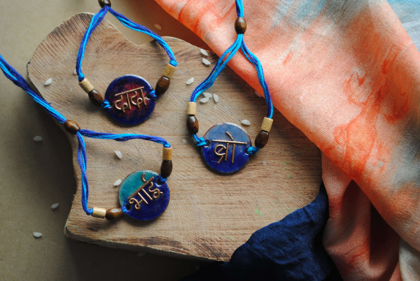 Handcrafted rakhi in beaten copper and enameled colours, one of its kind in devnagiri script