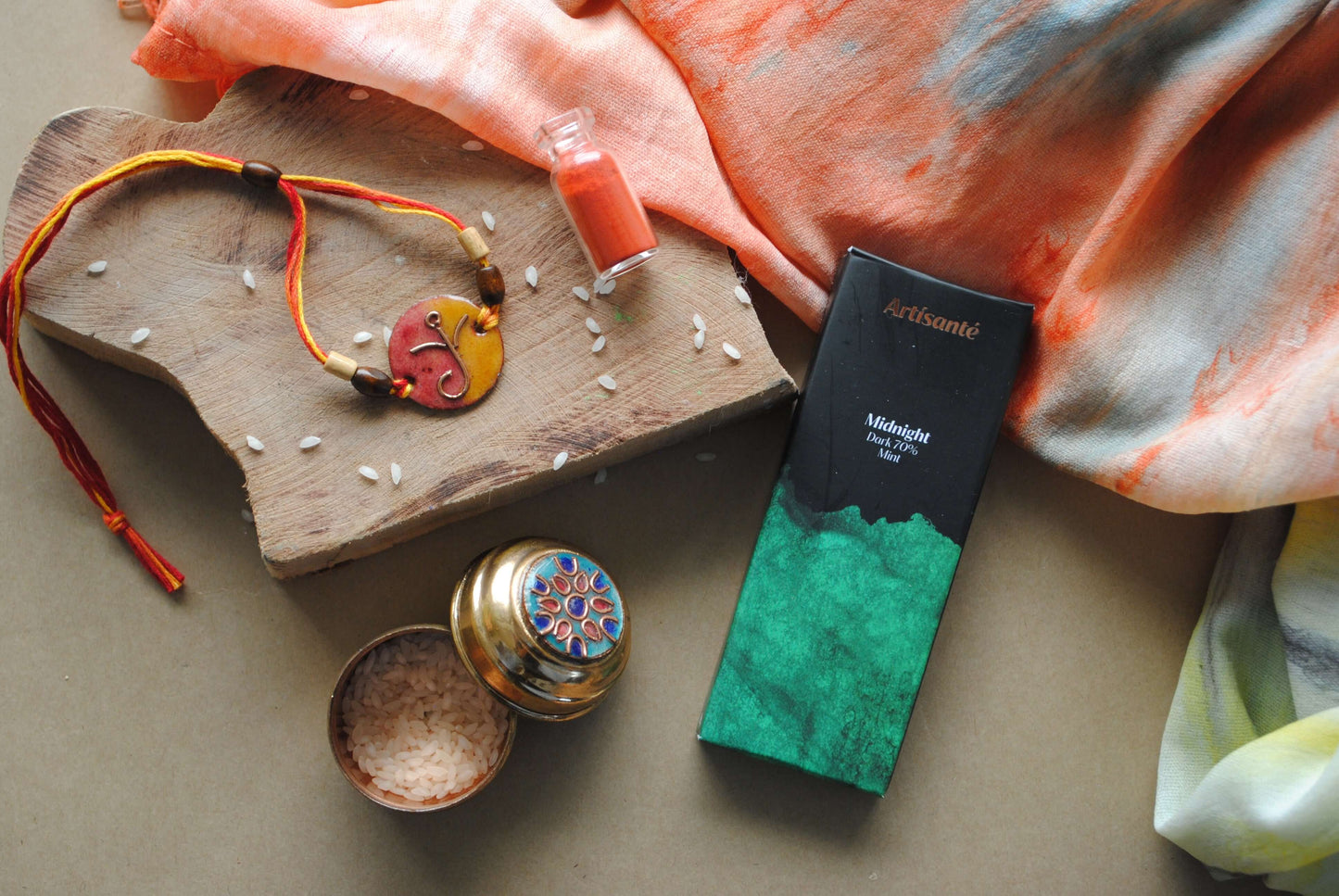 Handcrafted copper enameled rakhi with Ganesh motifs, string threads