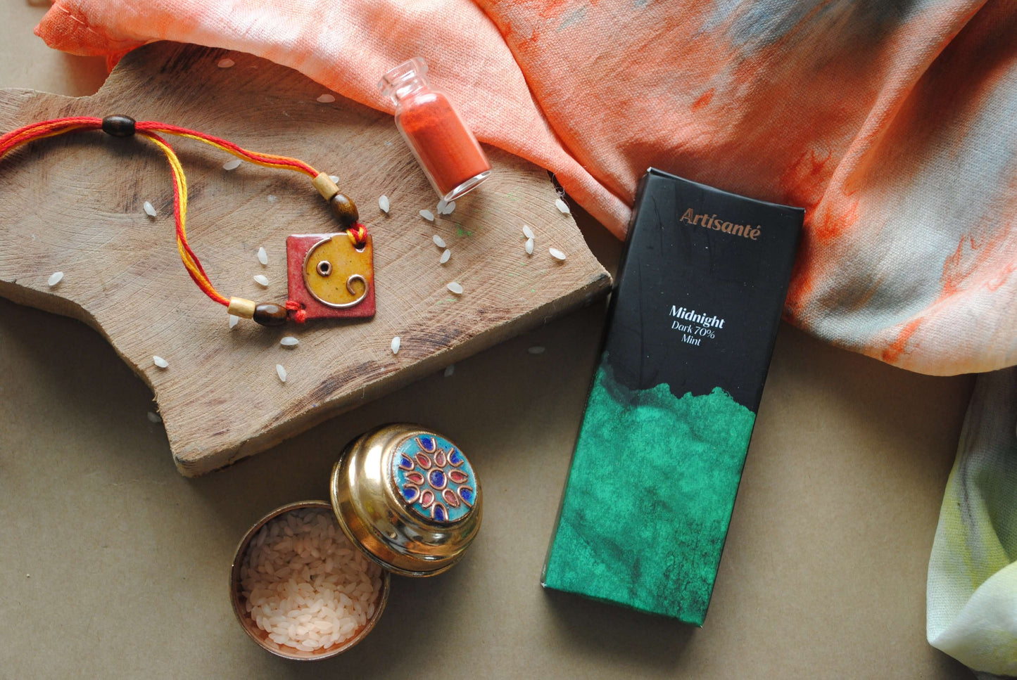 Handcrafted copper enameled rakhi with Ganesh motifs, string threads, square