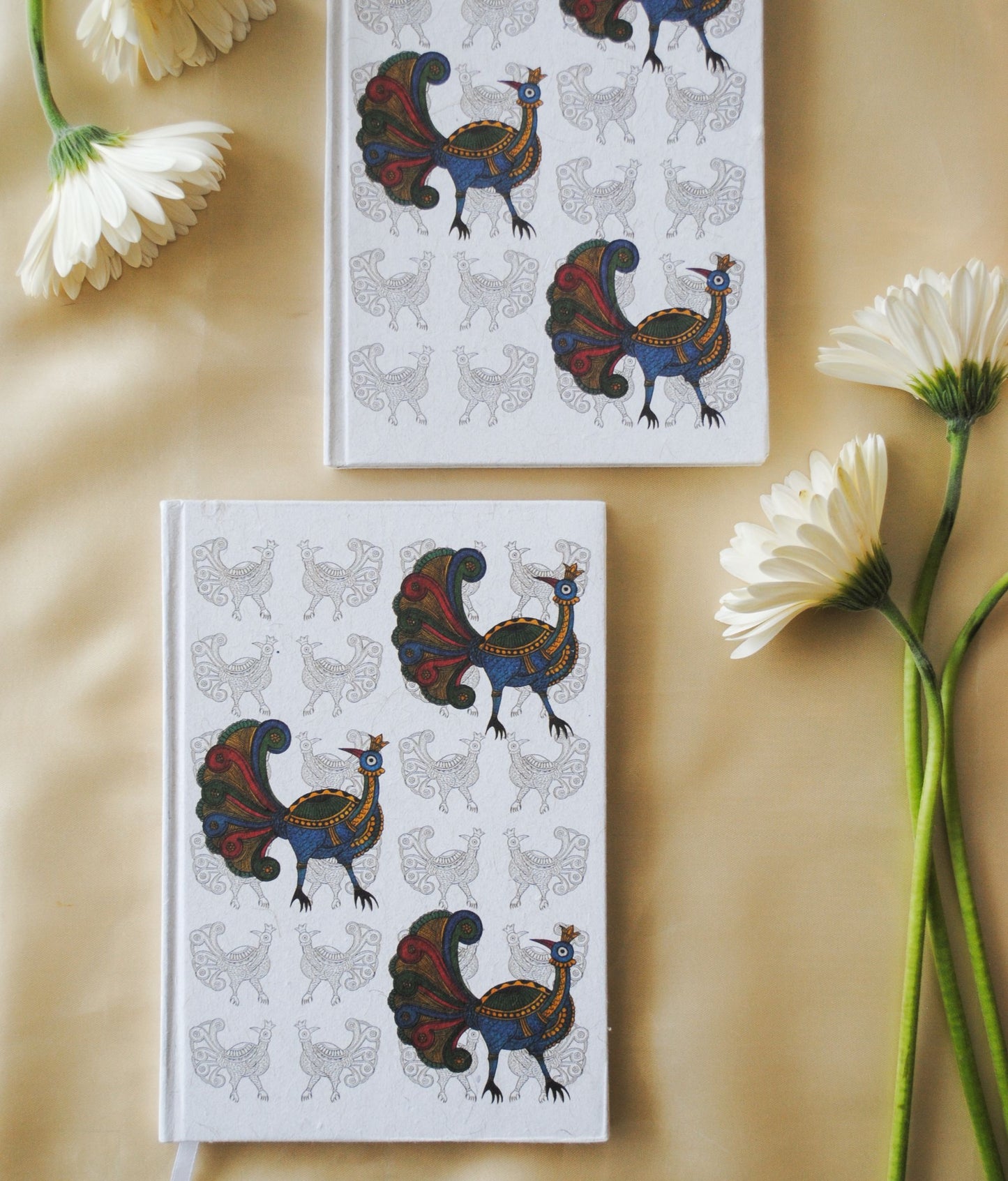 Artwork by native craftsmen of Chitrakathi, Gond, that are used as motifs to create stationery. This one is the peacock motif