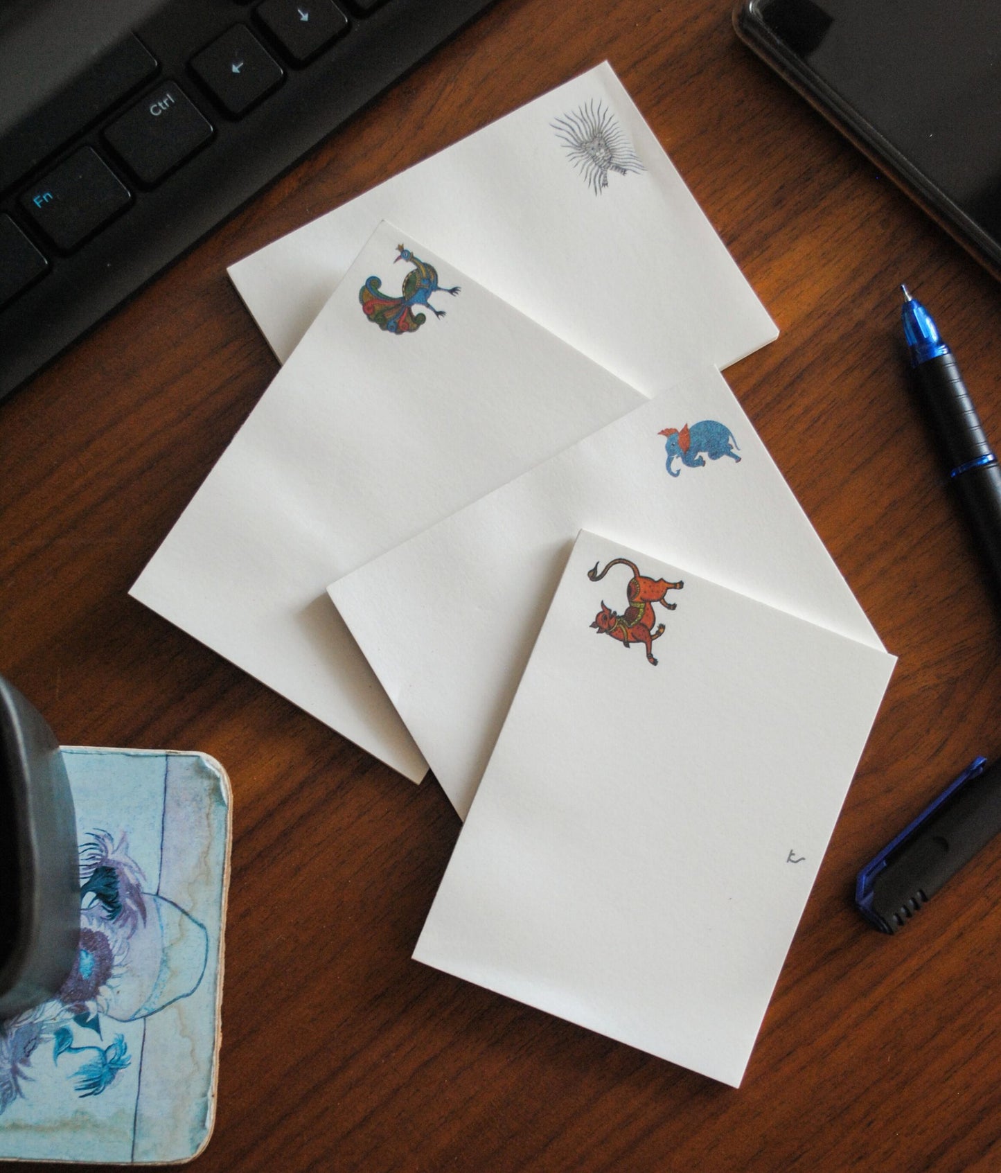 Artwork by native craftsmen of Chitrakathi, Gond, that are used as motifs to create stationery. This one is the gajoba elephant motif