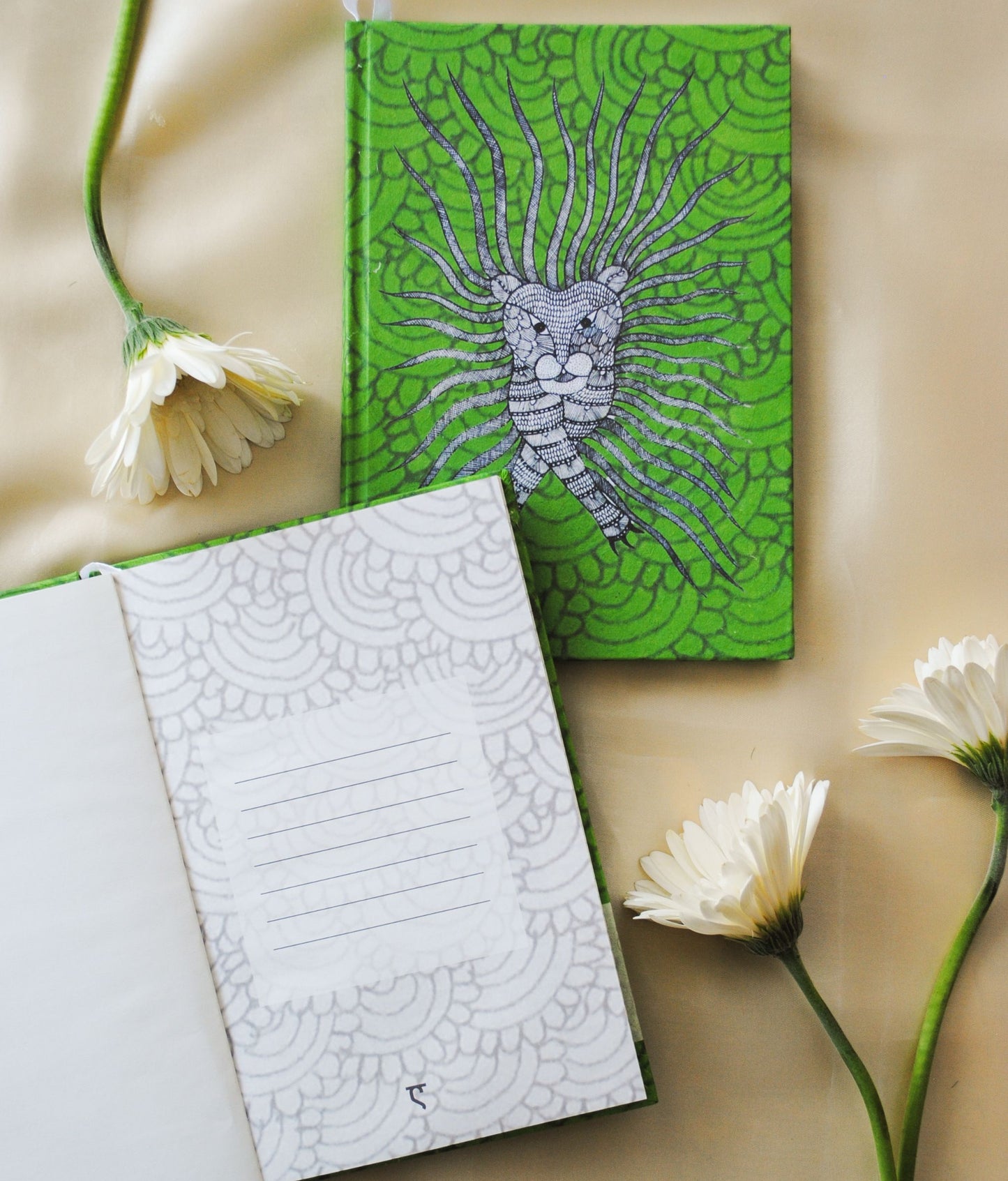 Artwork by native craftsmen of Chitrakathi, Gond, that are used as motifs to create stationery. This one is the waghoba lion motif