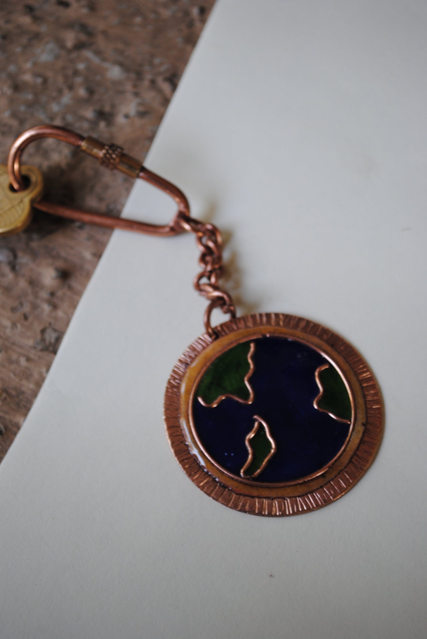 Copper enamel trinkets, funky keychains handcrafted in Maharashtra, India. World map theme