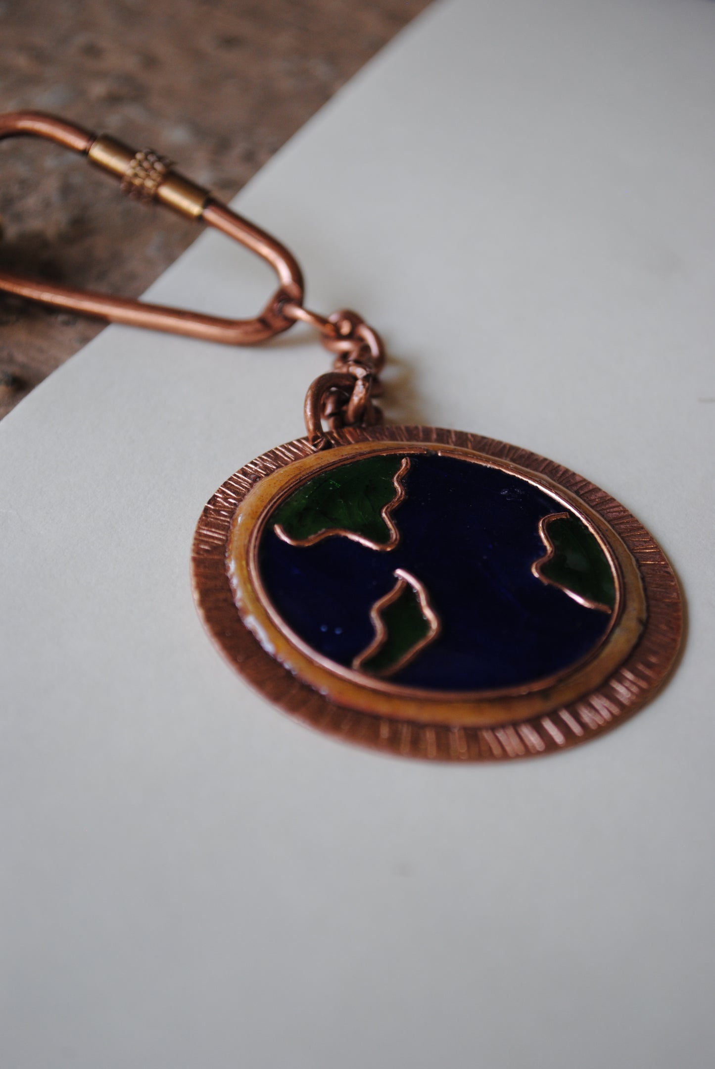 Copper enamel trinkets, funky keychains handcrafted in Maharashtra, India. World map theme
