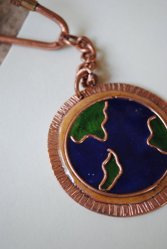 Copper enamel trinkets, funky keychains handcrafted in Maharashtra, India. World map theme