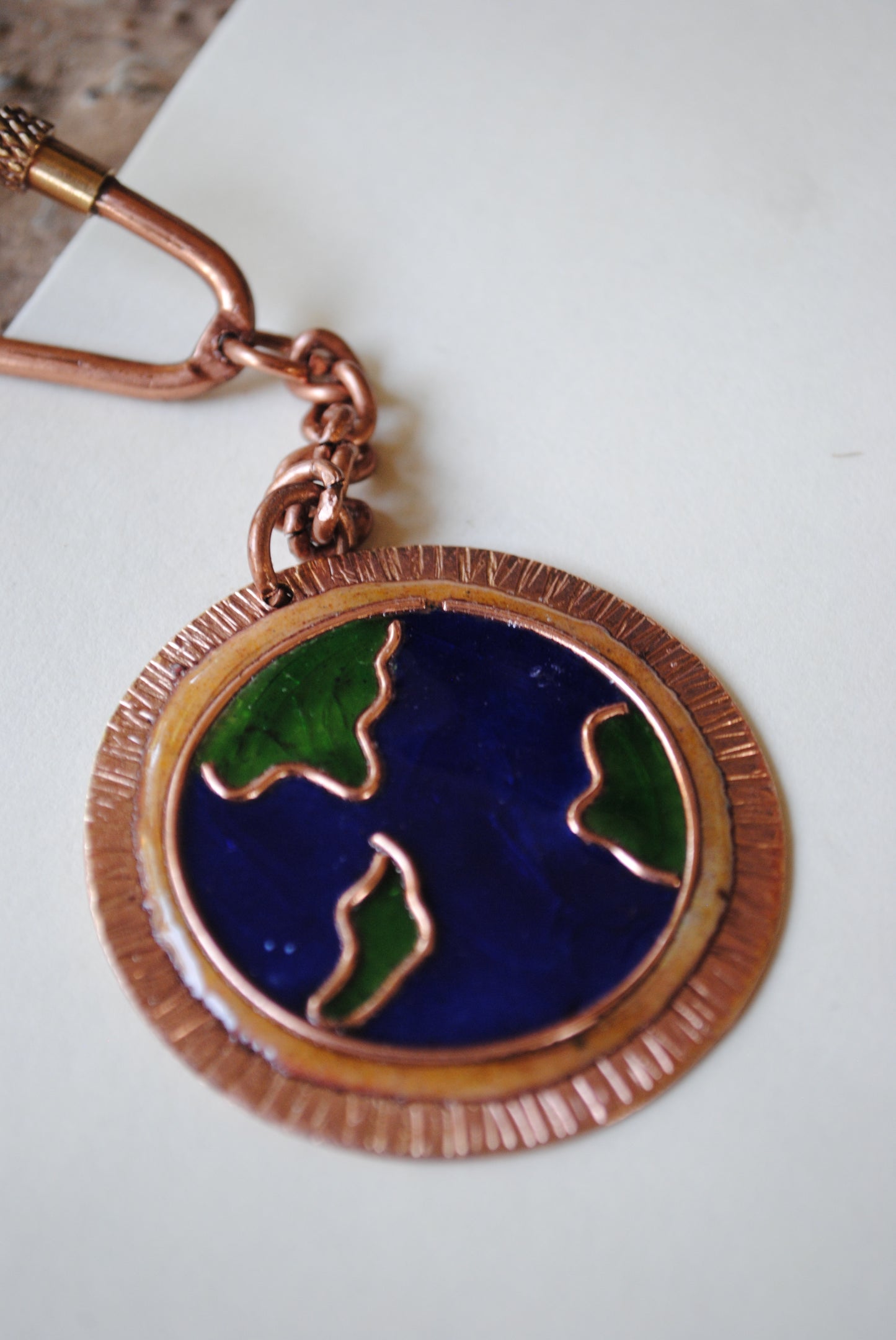 Copper enamel trinkets, funky keychains handcrafted in Maharashtra, India. World map theme
