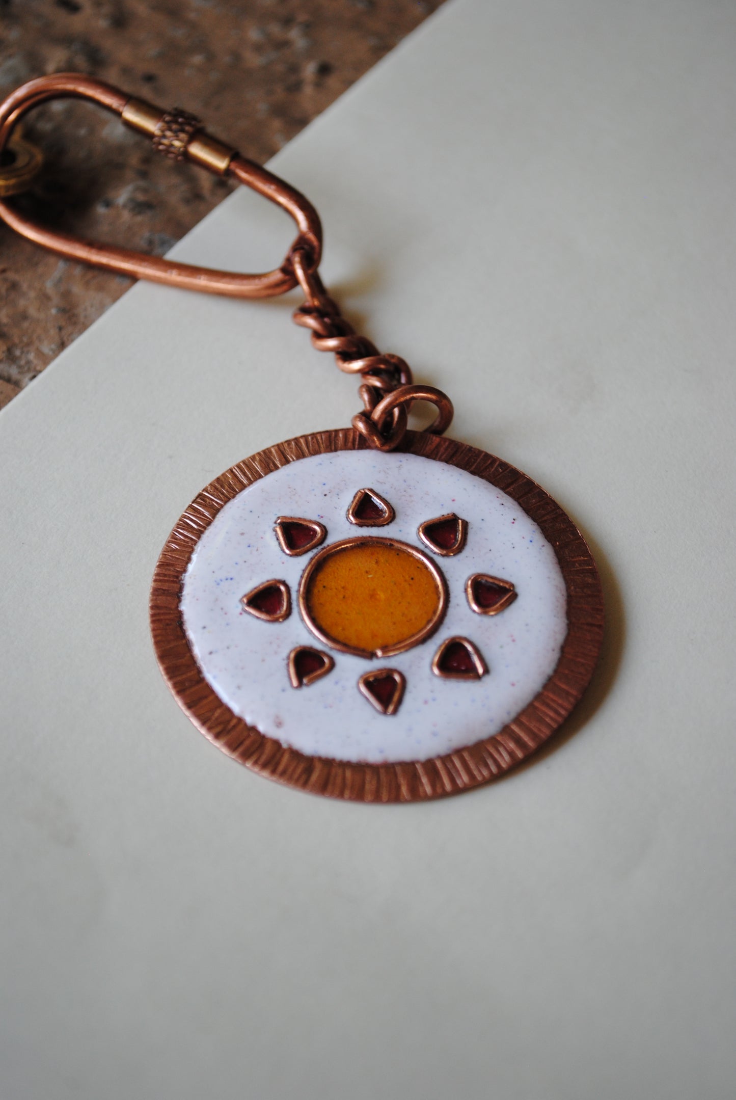 Copper enamel trinkets, funky keychains handcrafted in Maharashtra, India. Sooraj sun theme