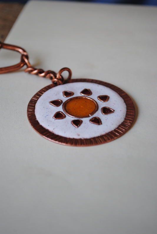 Copper enamel trinkets, funky keychains handcrafted in Maharashtra, India. Sooraj sun theme