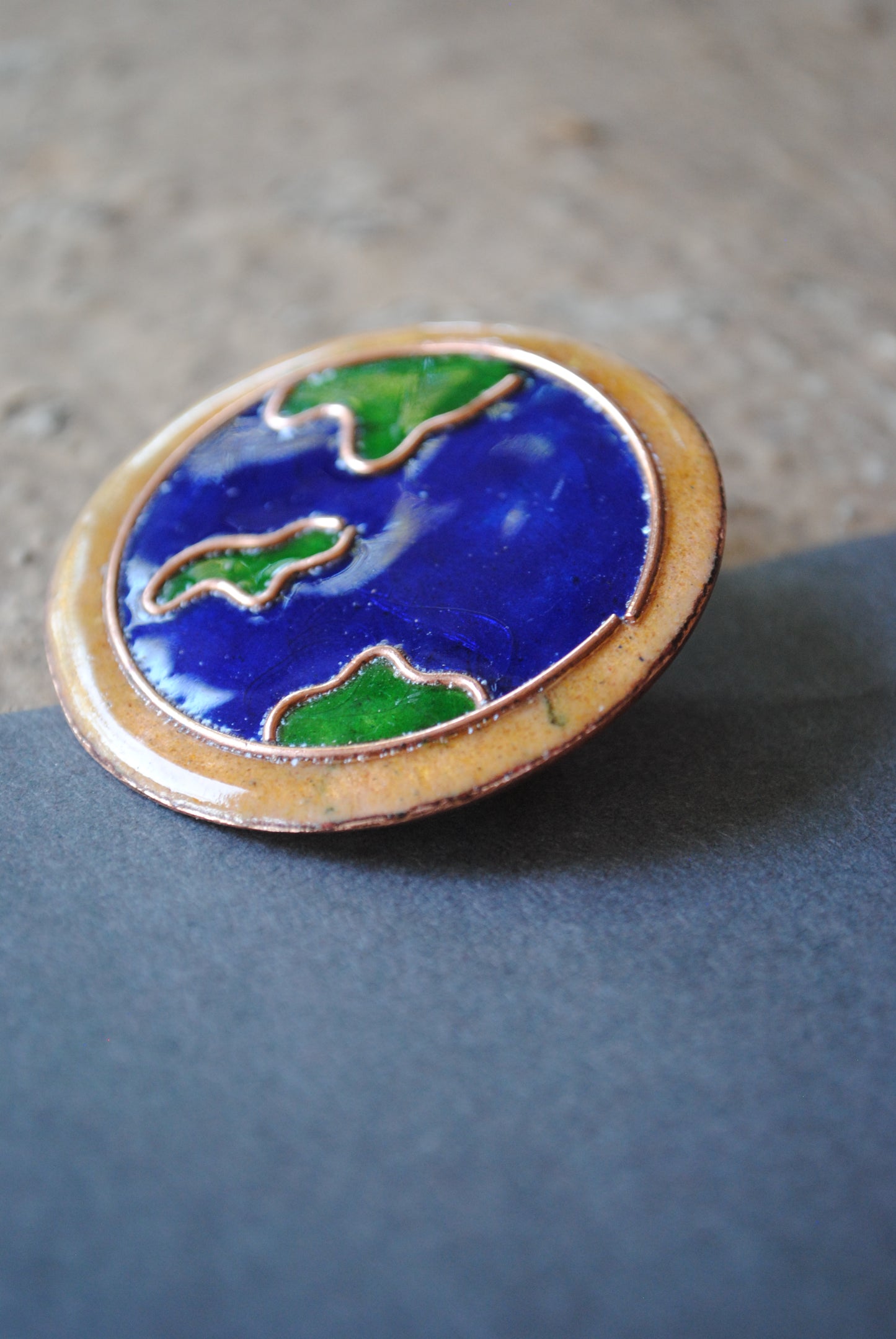 Copper enamel trinkets, funky lapel pins handcrafted in Maharashtra, India. World map theme
