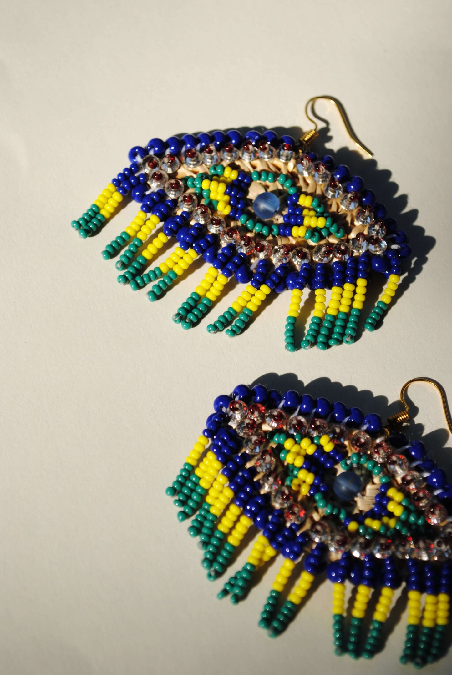 Truna natural fibre golden grass and zardosi handcrafted jewelry from Odisha, nazar blue earrings