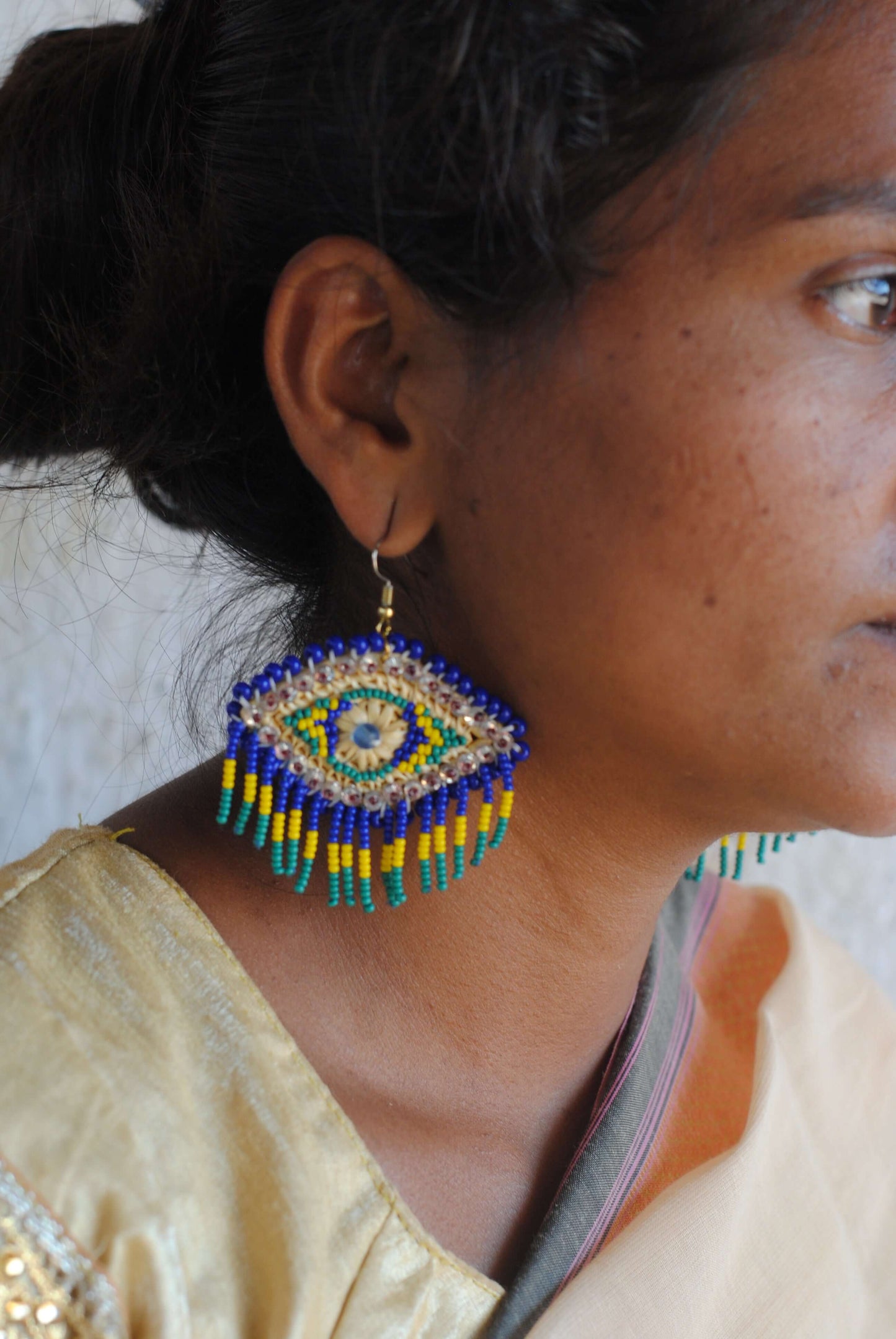 Truna natural fibre golden grass and zardosi handcrafted jewelry from Odisha, nazar blue earrings