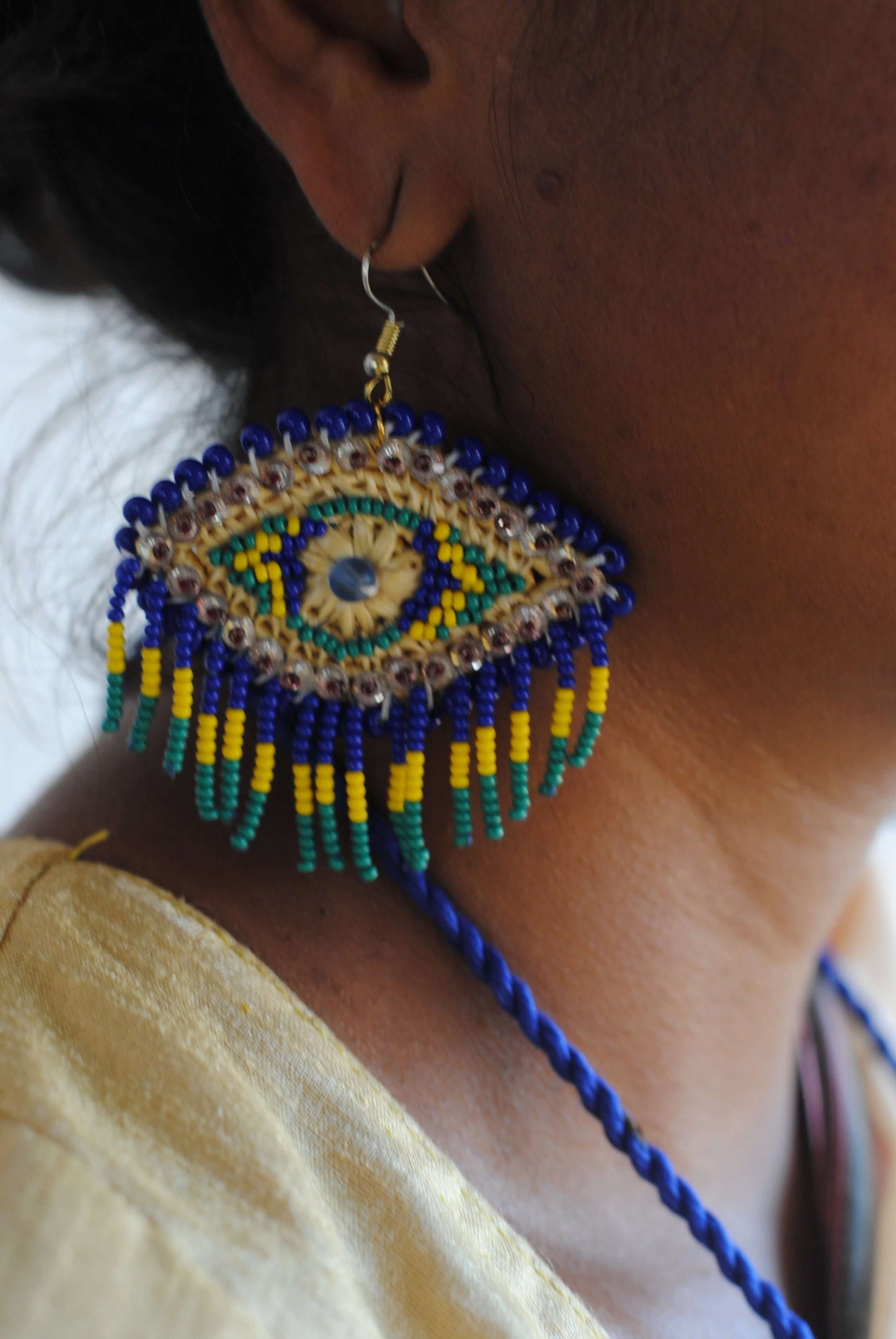 Truna natural fibre golden grass and zardosi handcrafted jewelry from Odisha, nazar blue earrings