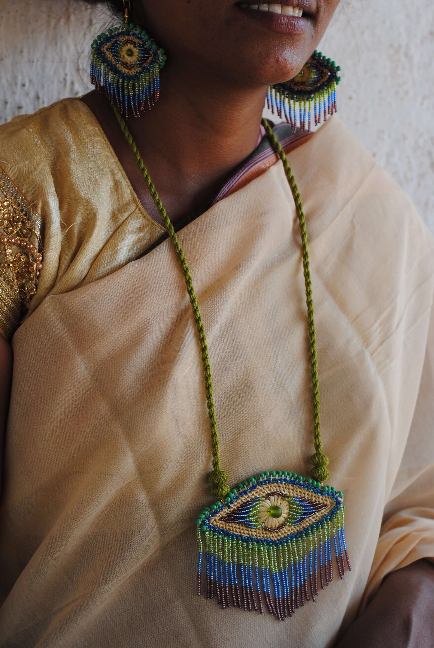 Truna natural fibre golden grass and zardosi handcrafted jewelry from Odisha, nazar peacock blue earrings and necklace set