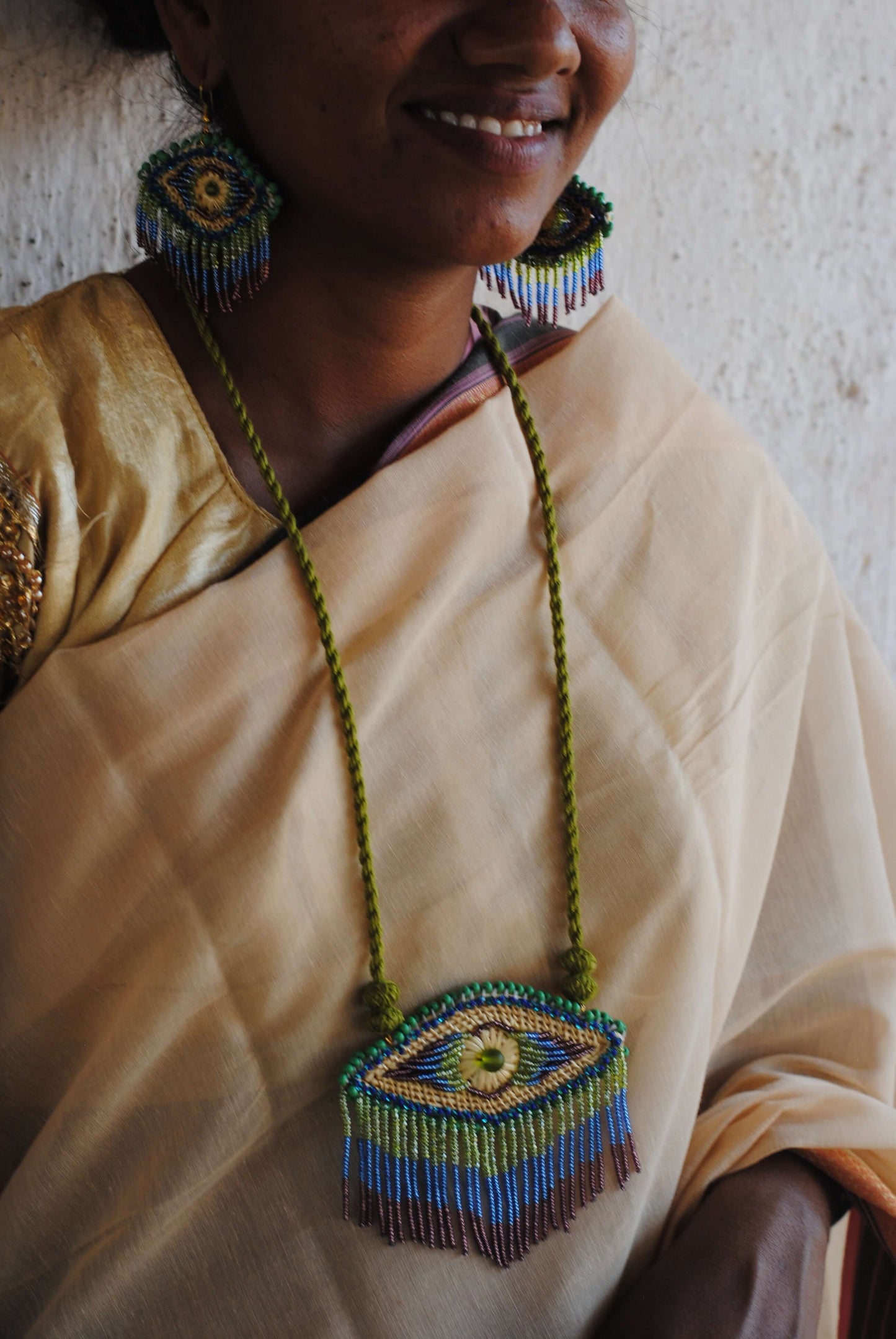 Truna natural fibre golden grass and zardosi handcrafted jewelry from Odisha, nazar peacock blue necklace and earrings