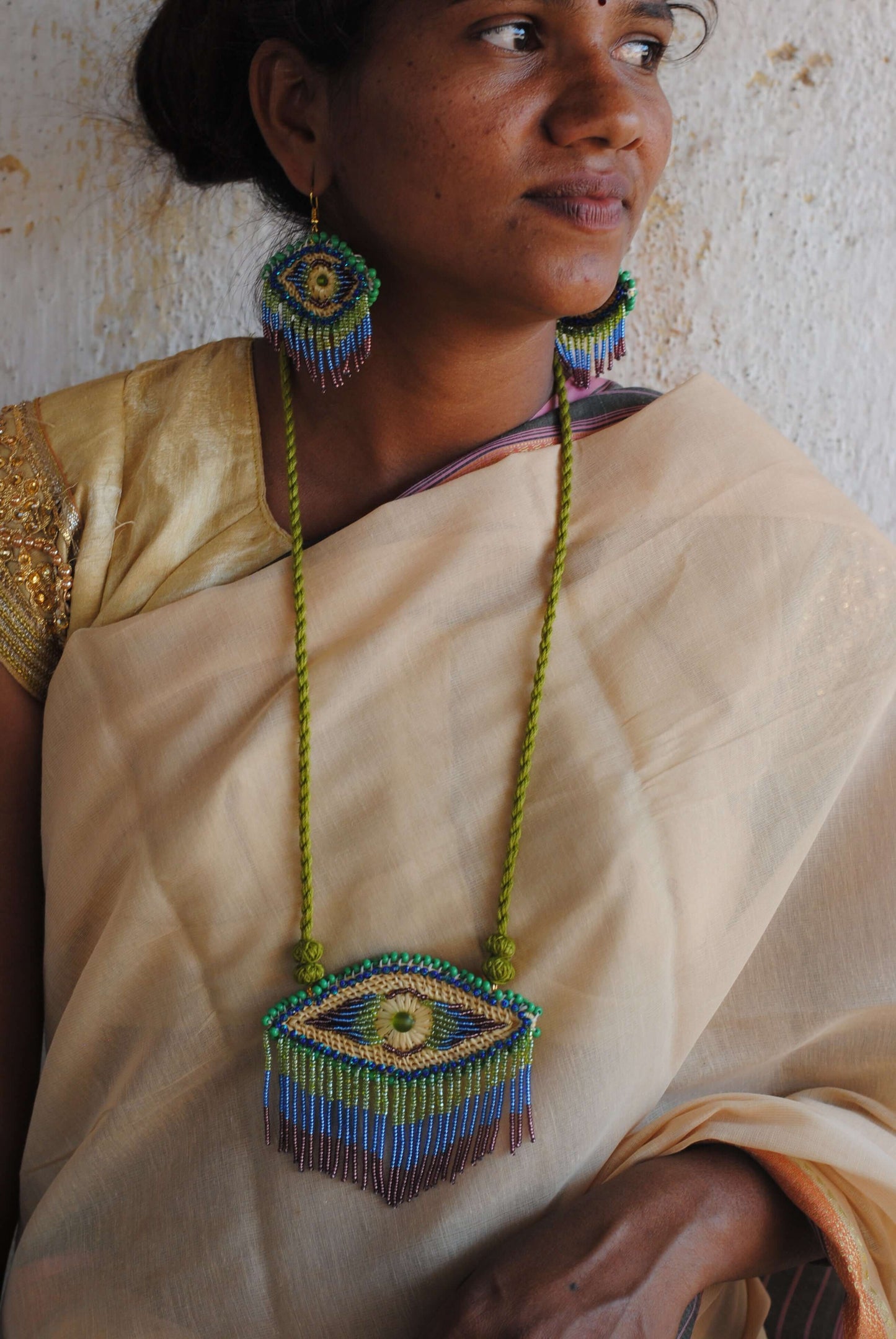 Truna natural fibre golden grass and zardosi handcrafted jewelry from Odisha, nazar peacock blue earrings and necklace set