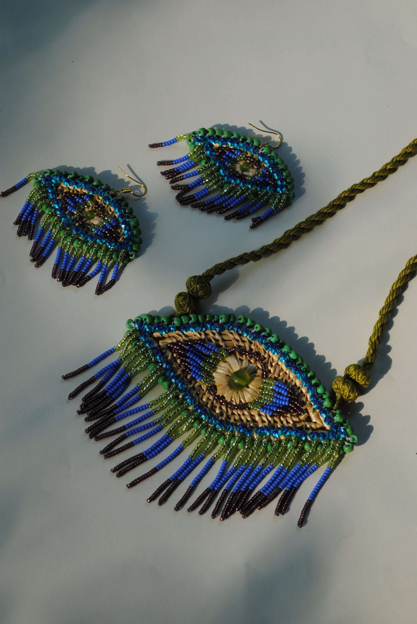 Truna natural fibre golden grass and zardosi handcrafted jewelry from Odisha, nazar peacock blue earrings and necklace set