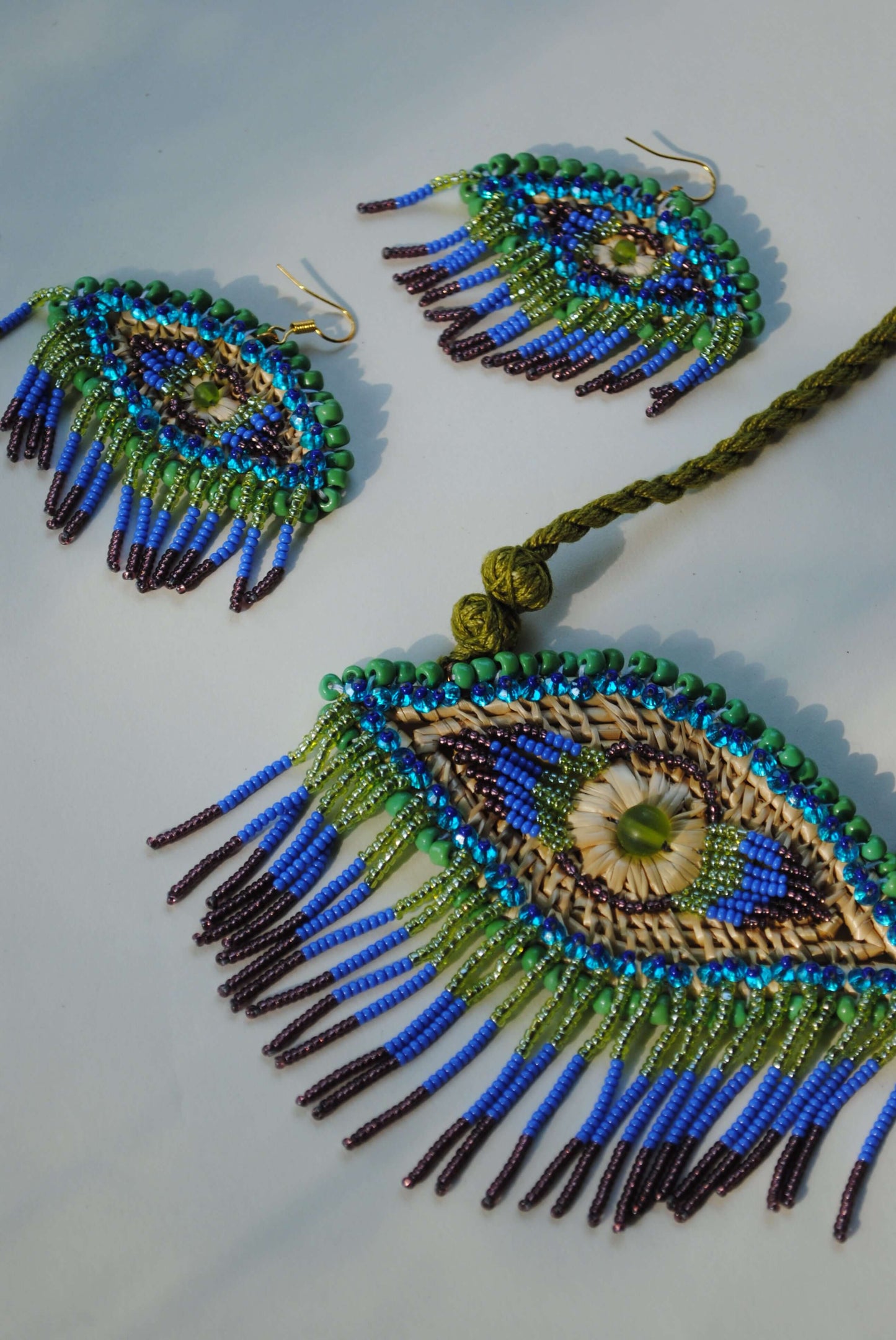 Truna natural fibre golden grass and zardosi handcrafted jewelry from Odisha, nazar peacock blue earrings and necklace set