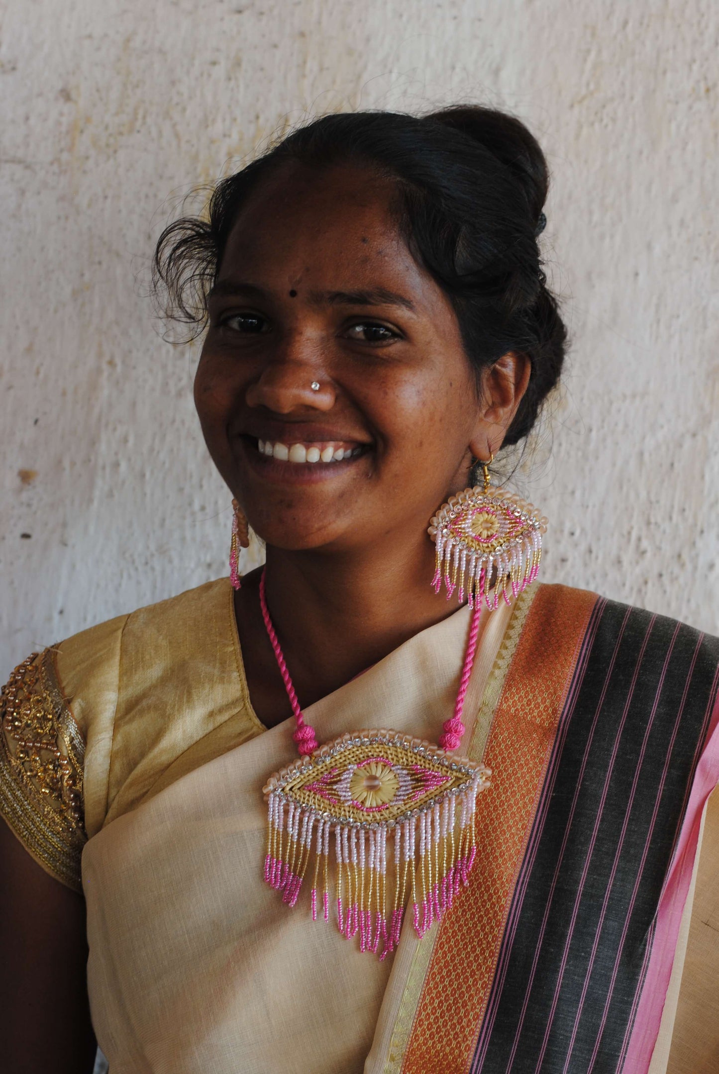 Truna natural fibre golden grass and zardosi handcrafted jewelry from Odisha, nazar pink pendant and earrings set