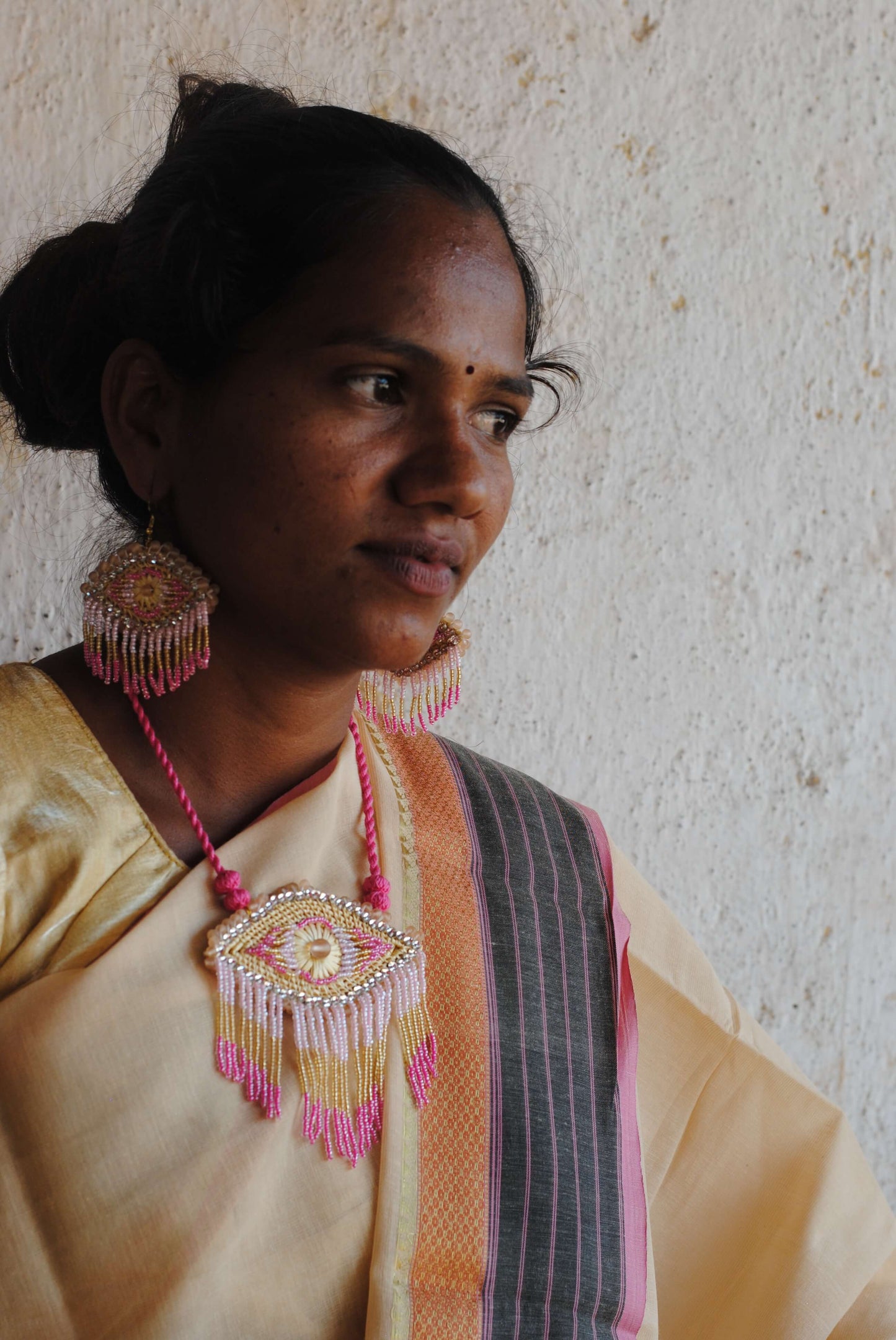 Truna natural fibre golden grass and zardosi handcrafted jewelry from Odisha, nazar pink pendant and earrings set