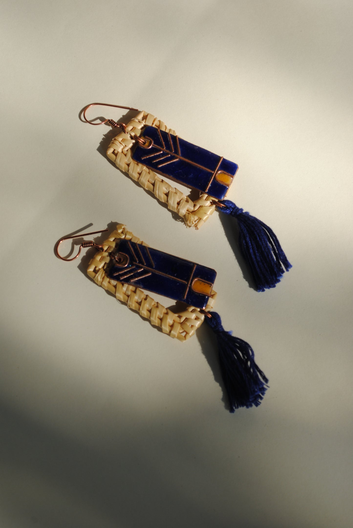 Truna natural fibre golden grass and copper enamel handcrafted jewelry from Odisha. Jharokha earrings in blue