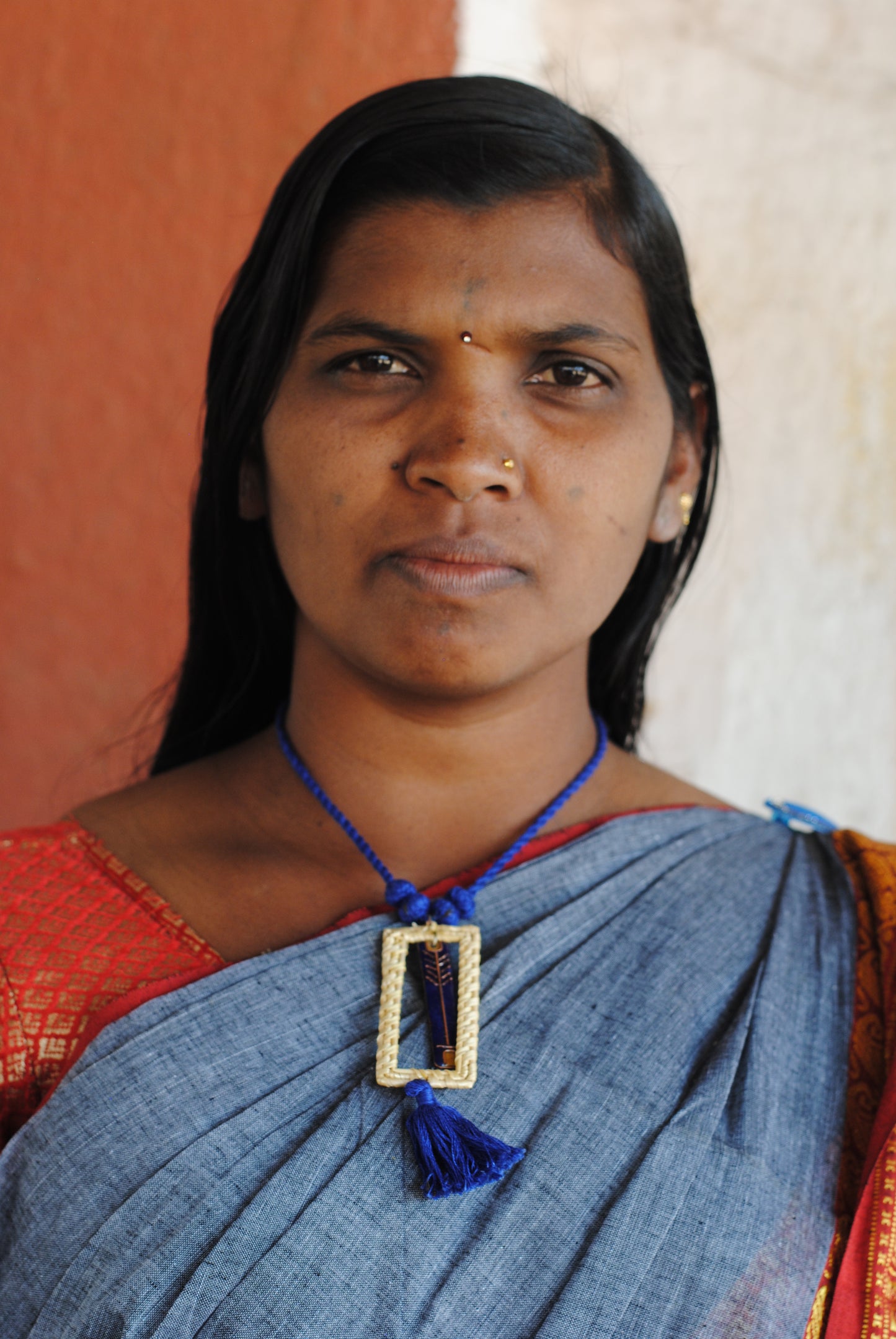 Truna natural fibre golden grass and copper enamel handcrafted jewelry from Odisha. Jharokha pendant in blue