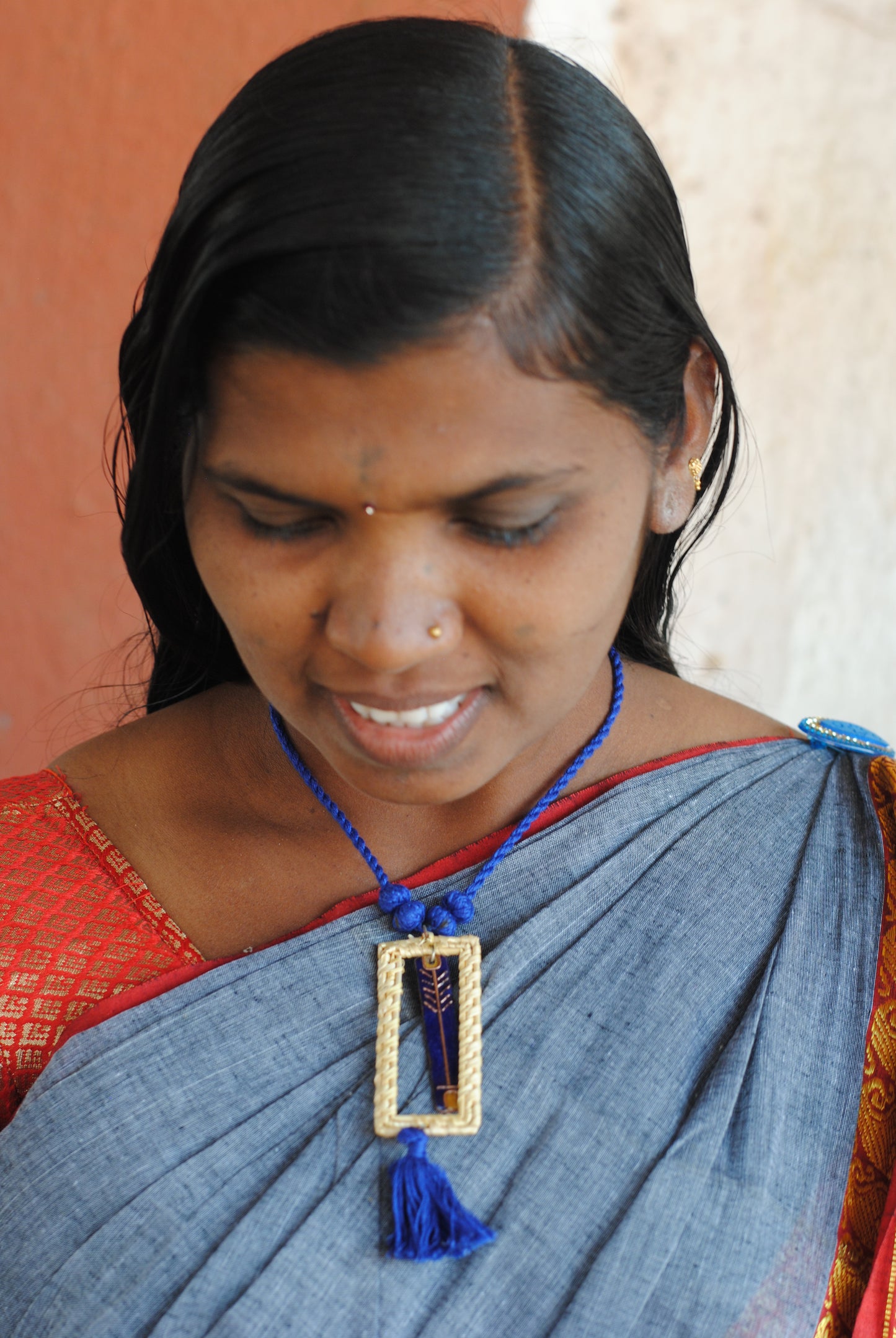 Truna natural fibre golden grass and copper enamel handcrafted jewelry from Odisha. Jharokha pendant in blue