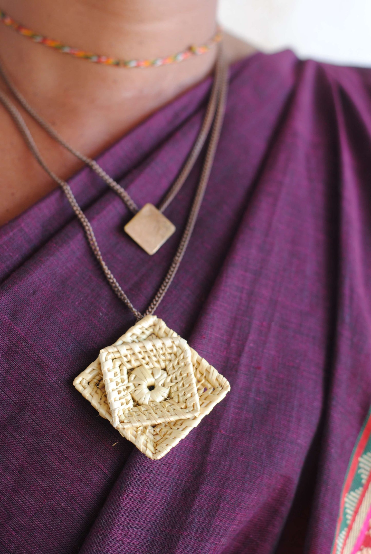 Truna natural fibre golden grass and beaten copper handcrafted jewelry from Odisha, Chaukon pendant