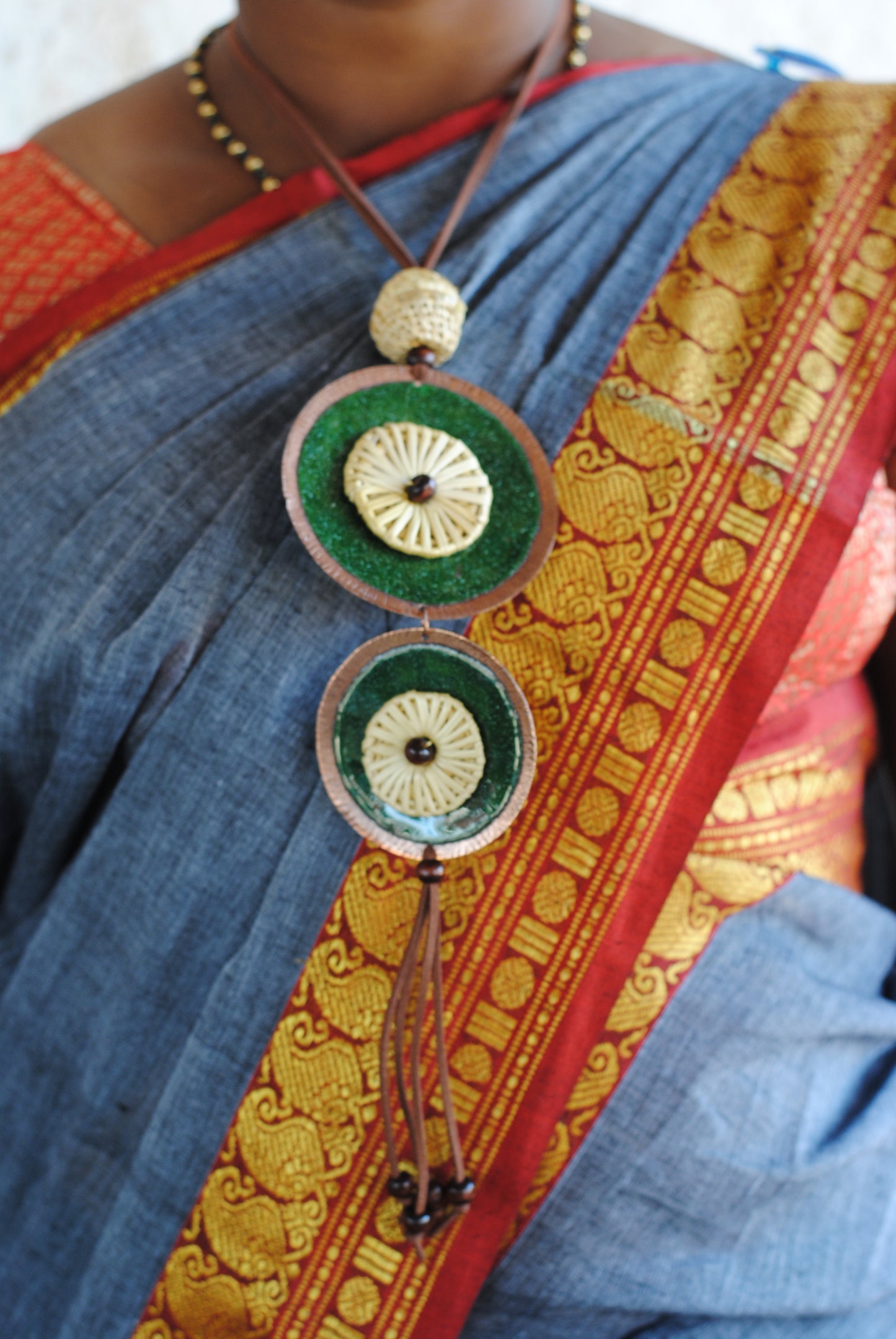 Truna natural fibre golden grass and copper enamel handcrafted jewelry from Odisha, Vaati green enamel pendant