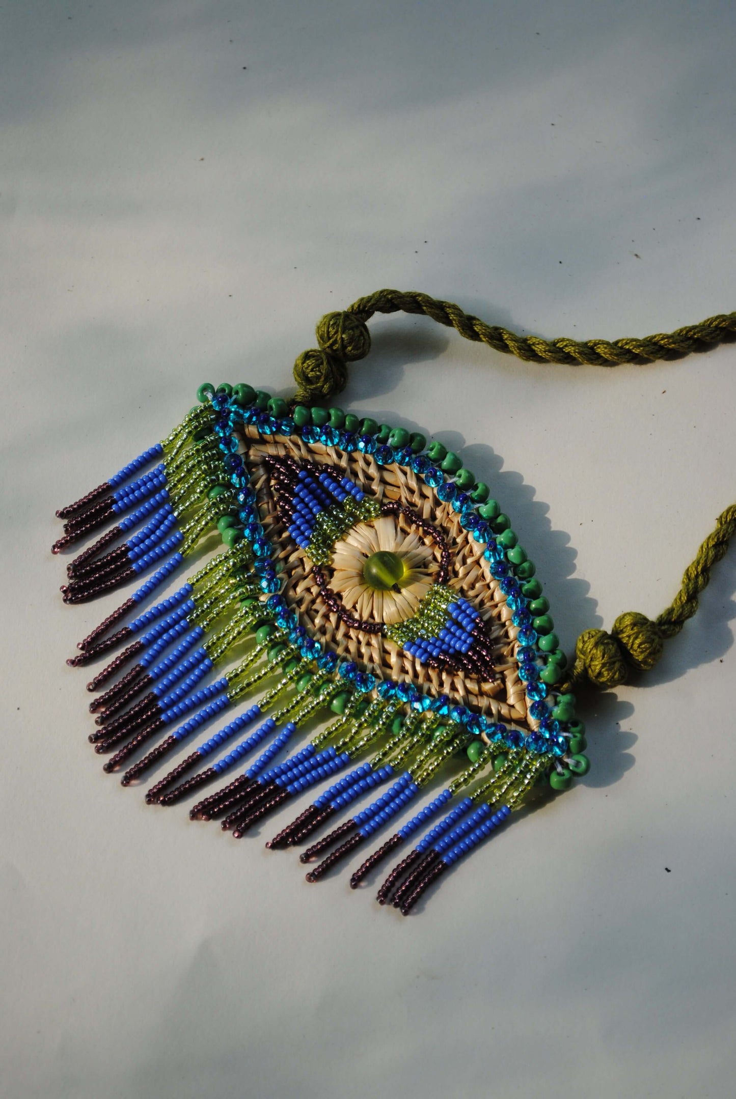 Truna natural fibre golden grass and zardosi handcrafted jewelry from Odisha, nazar blue pendant