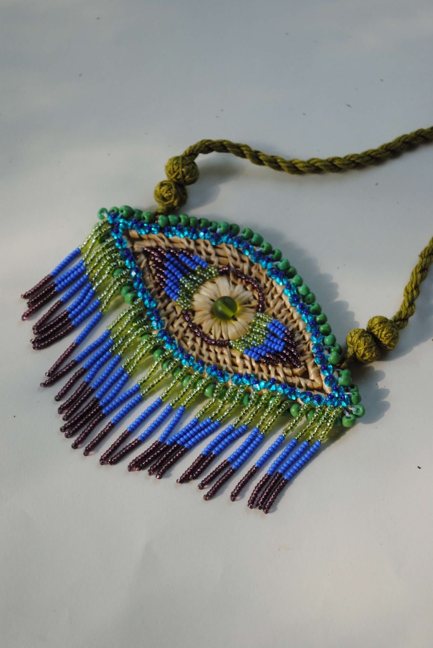 Truna natural fibre golden grass and zardosi handcrafted jewelry from Odisha, nazar blue pendant