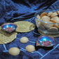 Gift box with handcrafted copper enamel lamps, handwoven coasters and mini cookies