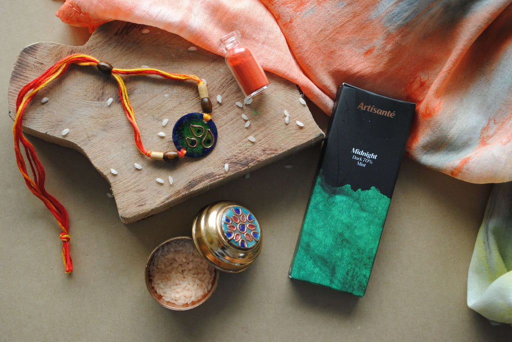 Handcrafted copper enameled rakhi with funky peacock morpankh motif, with a chocolate gift hamper for your sibling