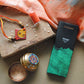 Handcrafted copper enameled rakhi with Ganesh motifs, string threads, square