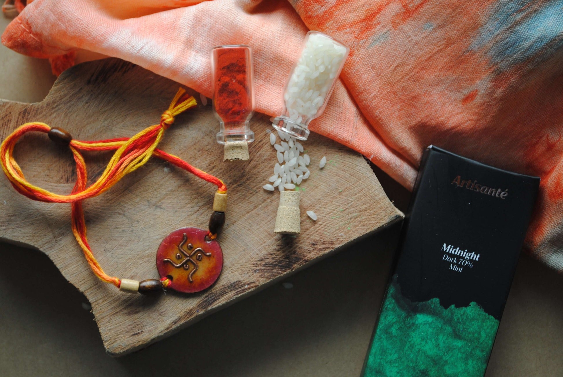 Handcrafted copper enameled rakhi with swastika motifs, string threads. Part of chocolate gift hamper 