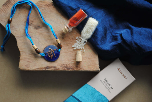 Handcrafted copper enameled rakhi with "bro" in devnagiri, with a chocolate gift hamper for brothers