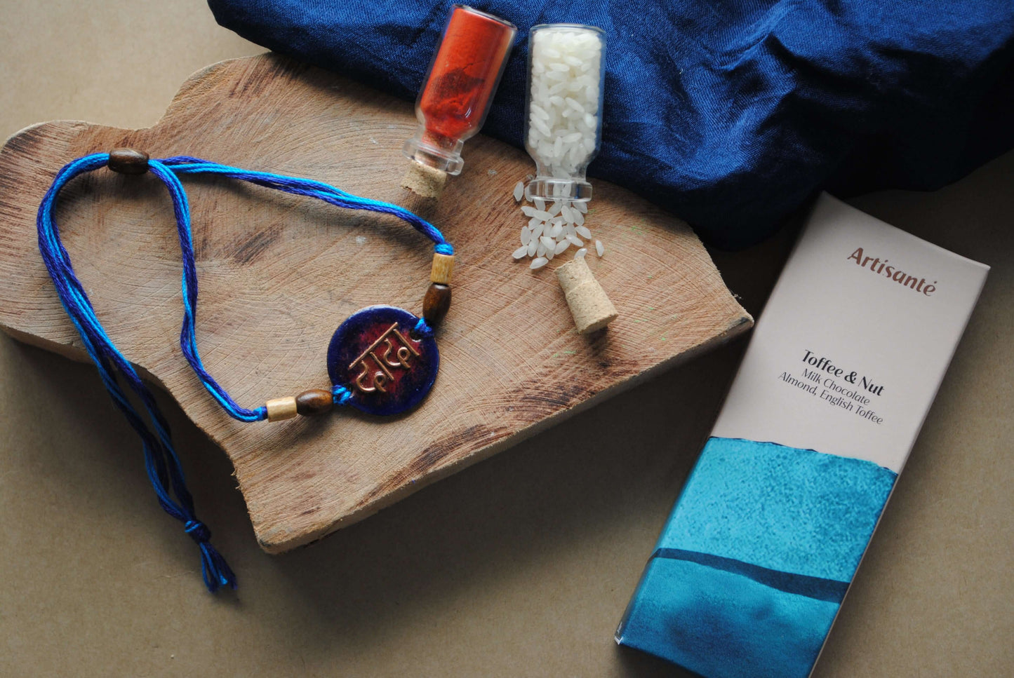 Handcrafted copper enameled rakhi with dada in devnagiri, with a chocolate gift hamper for brothers