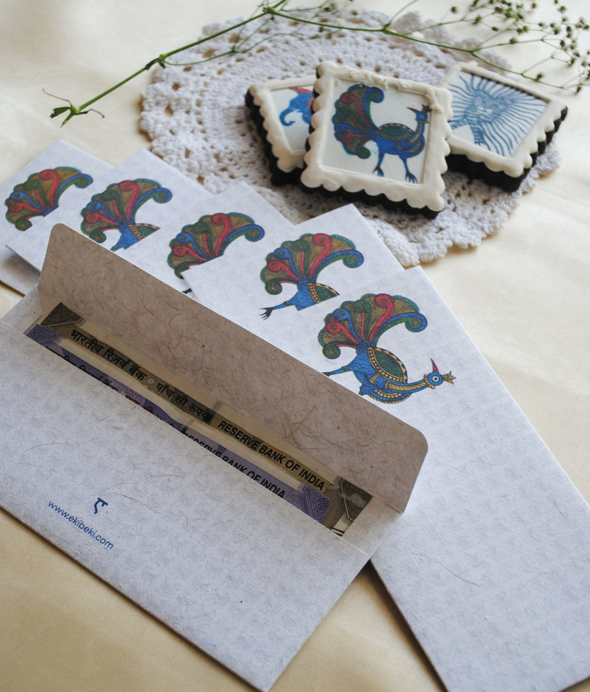 Artwork by native craftsmen of Chitrakathi, Gond, that are used as motifs to create stationery. This one is the peacock motif