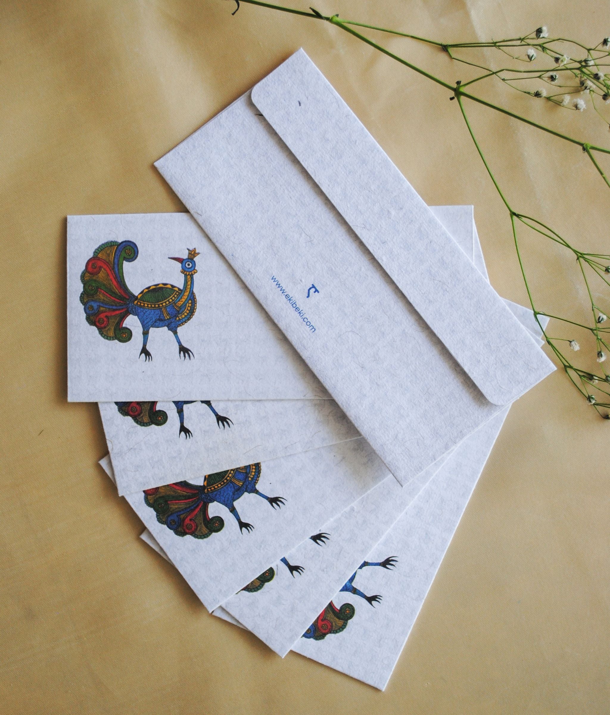 Artwork by native craftsmen of Chitrakathi, Gond, that are used as motifs to create stationery. This one is the peacock motif