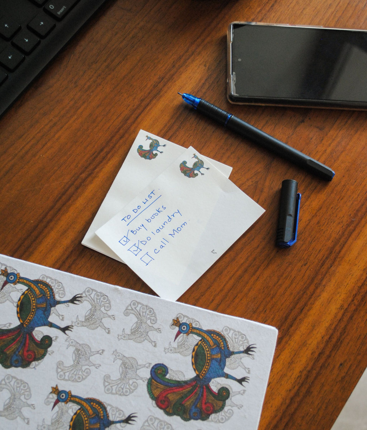 Artwork by native craftsmen of Chitrakathi, Gond, that are used as motifs to create stationery. This one is the peacock motif