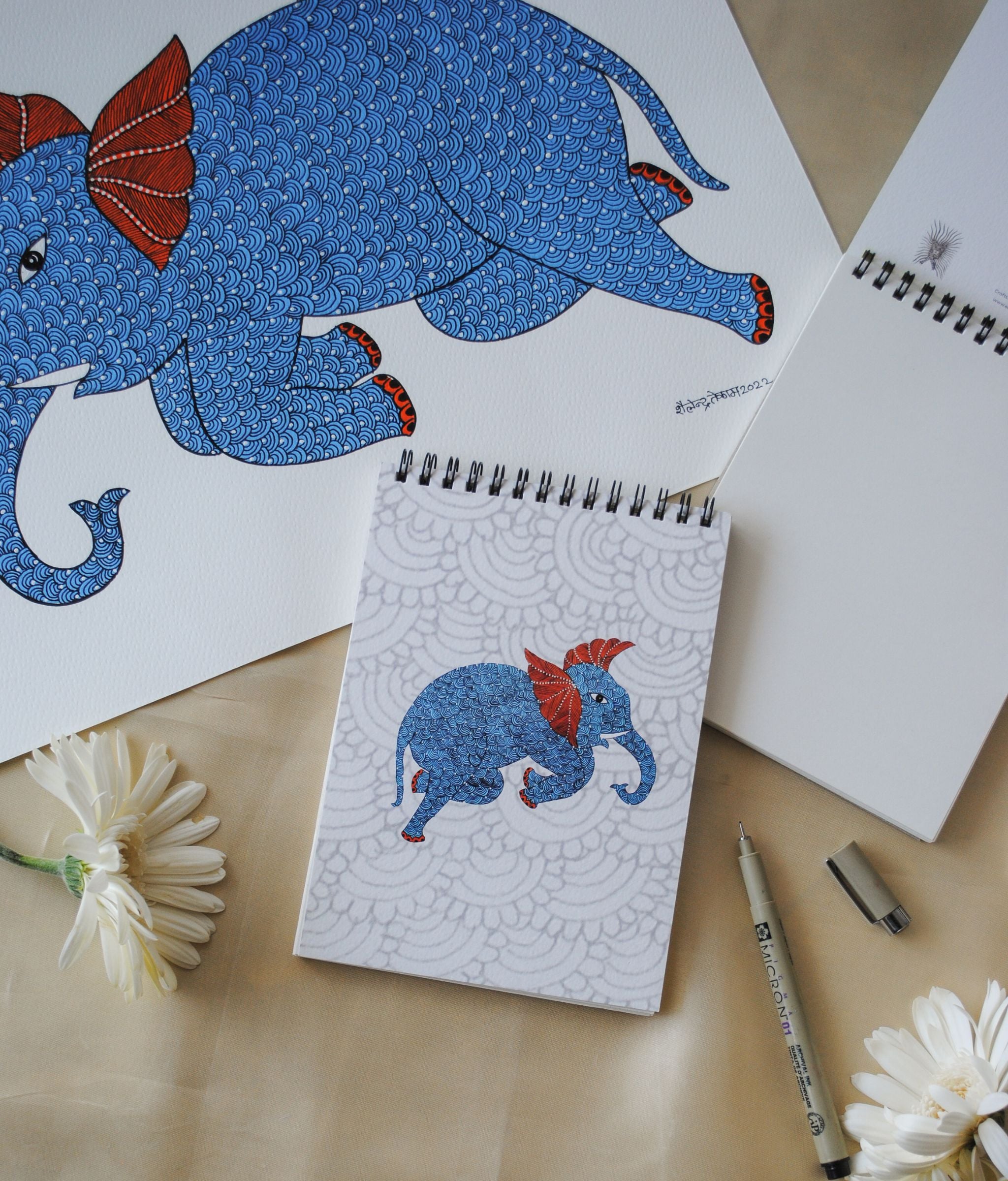 Artwork by native craftsmen of Chitrakathi, Gond, that are used as motifs to create stationery. This one is the gajoba elephant motif