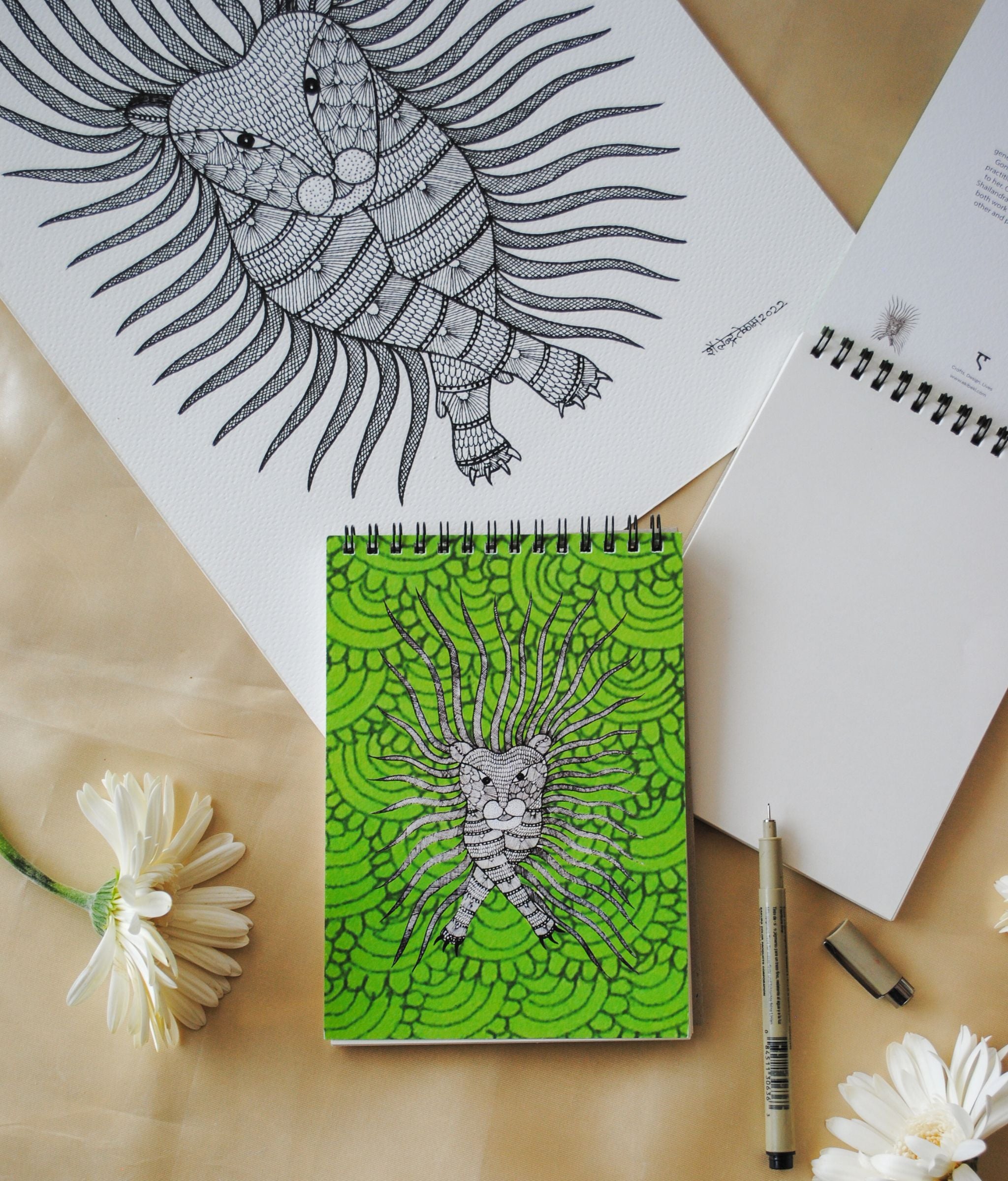 Artwork by native craftsmen of Chitrakathi, Gond, that are used as motifs to create stationery. This one is the waghoba lion motif