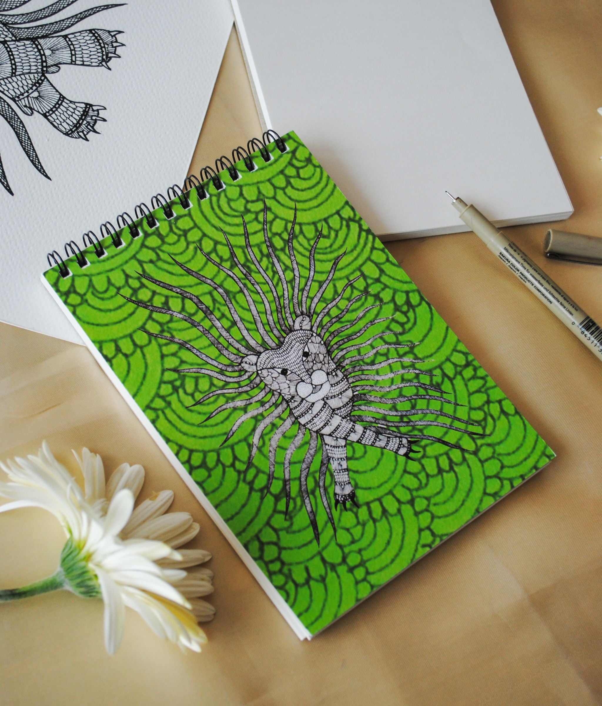 Artwork by native craftsmen of Chitrakathi, Gond, that are used as motifs to create stationery. This one is the waghoba lion motif