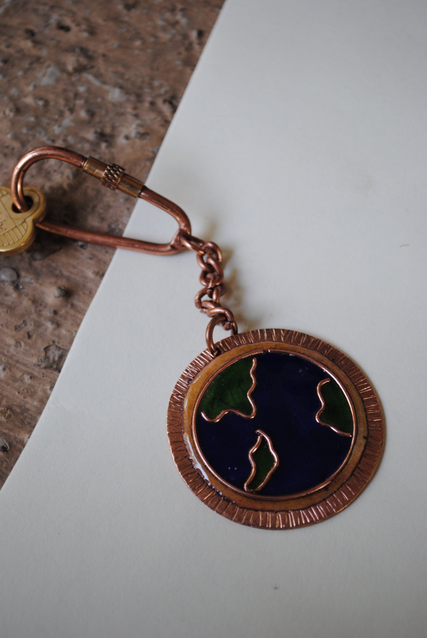 Copper enamel trinkets, funky keychains handcrafted in Maharashtra, India. World map theme