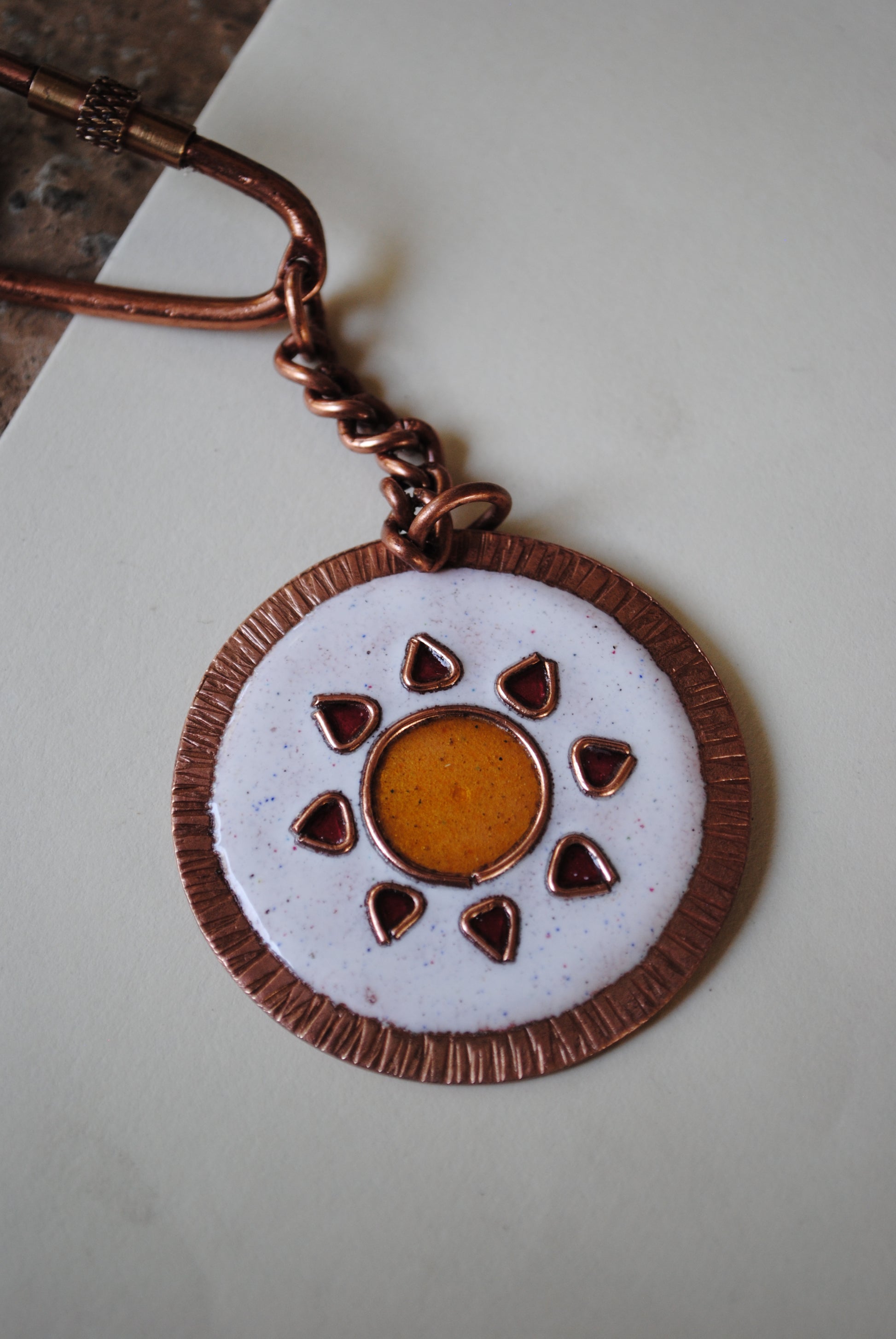 Copper enamel trinkets, funky keychains handcrafted in Maharashtra, India. Sooraj sun theme