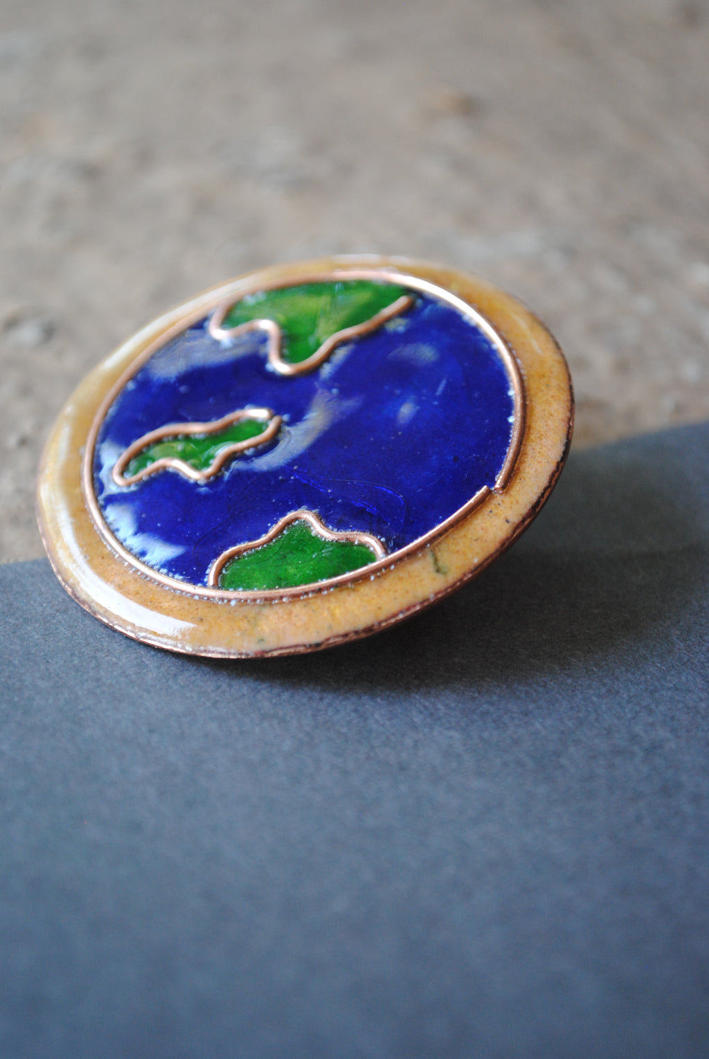 Copper enamel trinkets, funky lapel pins handcrafted in Maharashtra, India. World map theme