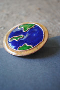 Copper enamel trinkets, funky lapel pins handcrafted in Maharashtra, India. World map theme
