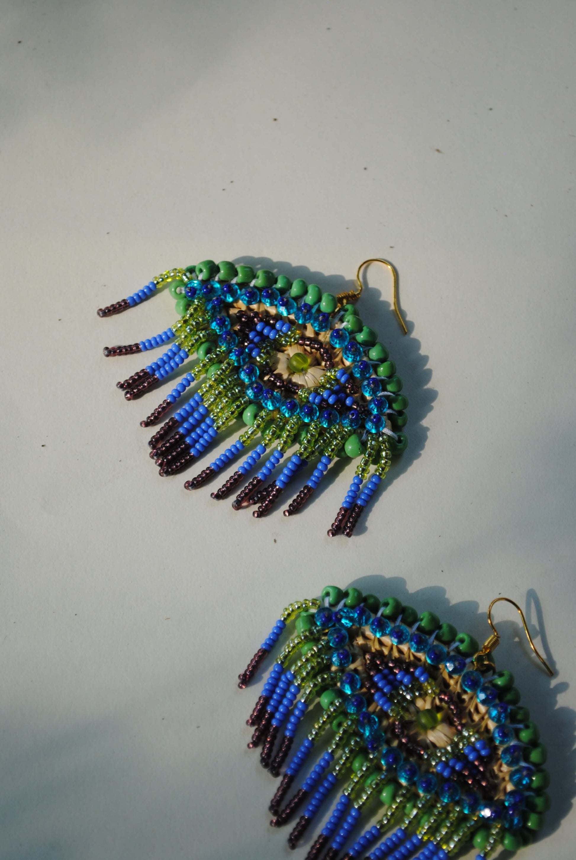 Truna natural fibre golden grass and zardosi handcrafted jewelry from Odisha, nazar peacock blue earrings set