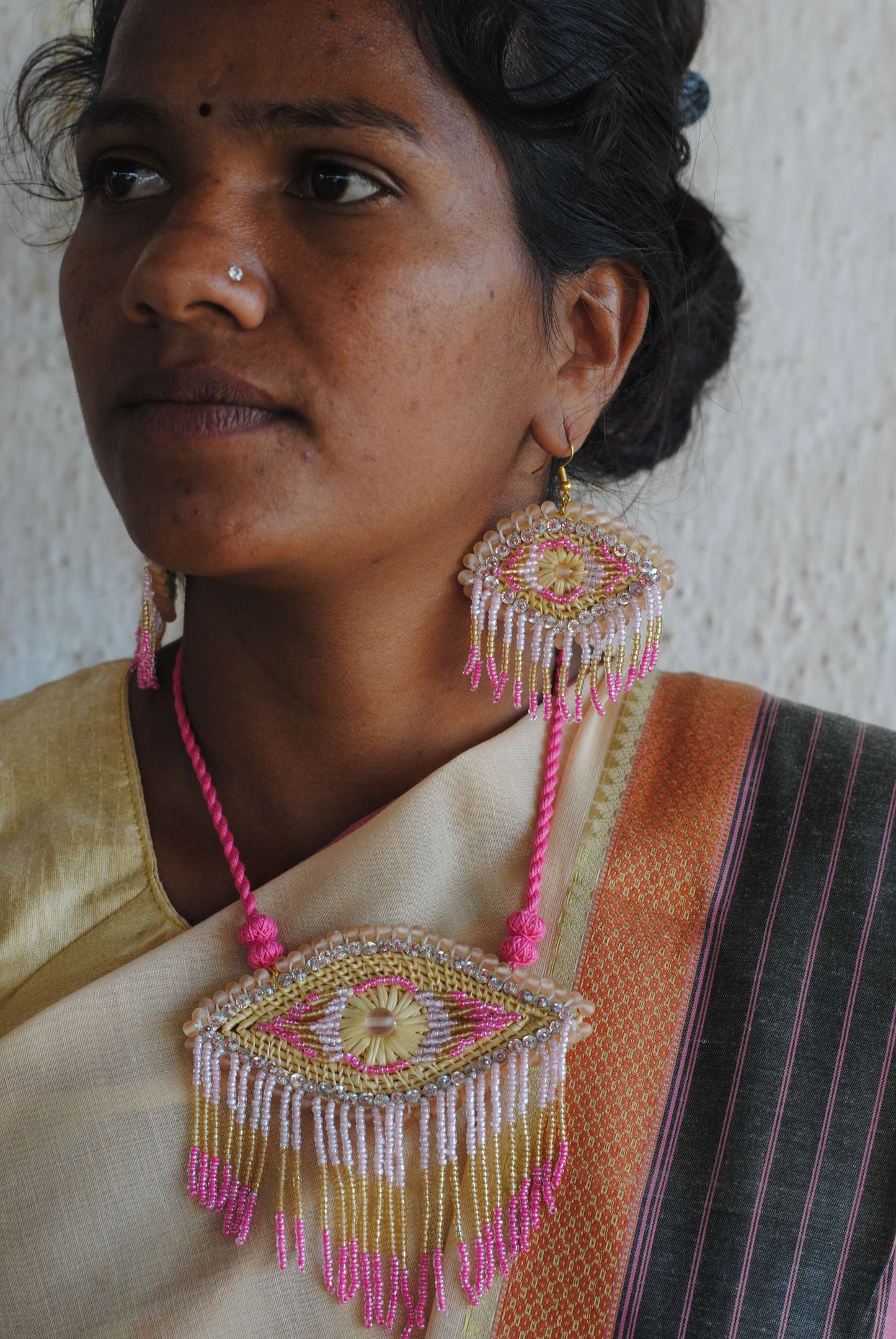 Truna natural fibre golden grass and zardosi handcrafted jewelry from Odisha, nazar pink pendant and earrings set