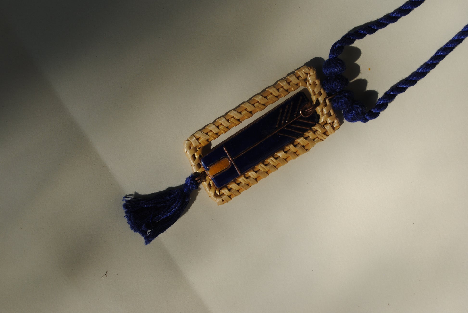 Truna natural fibre golden grass and copper enamel handcrafted jewelry from Odisha. Jharokha pendant in blue