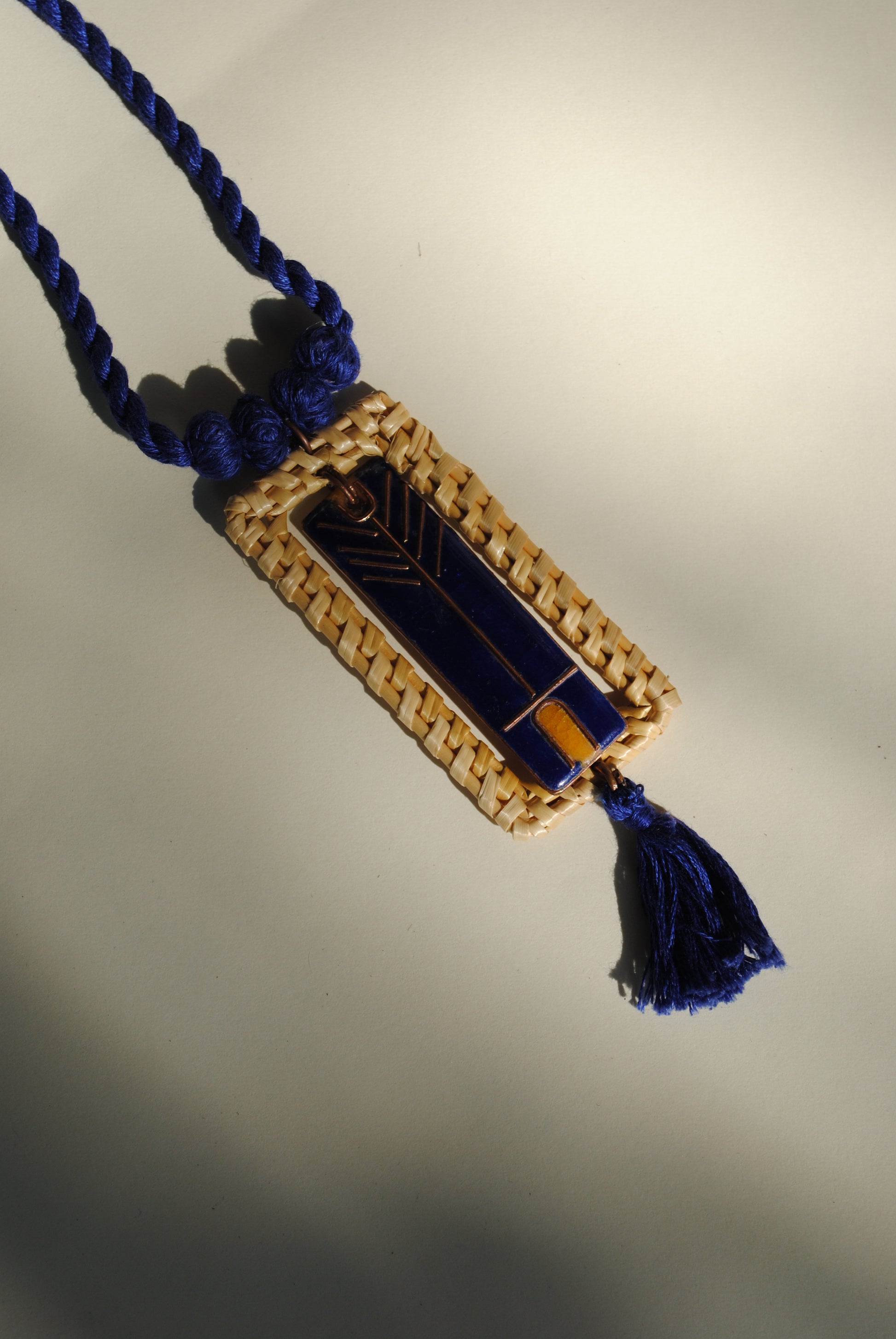 Truna natural fibre golden grass and copper enamel handcrafted jewelry from Odisha. Jharokha pendant in blue